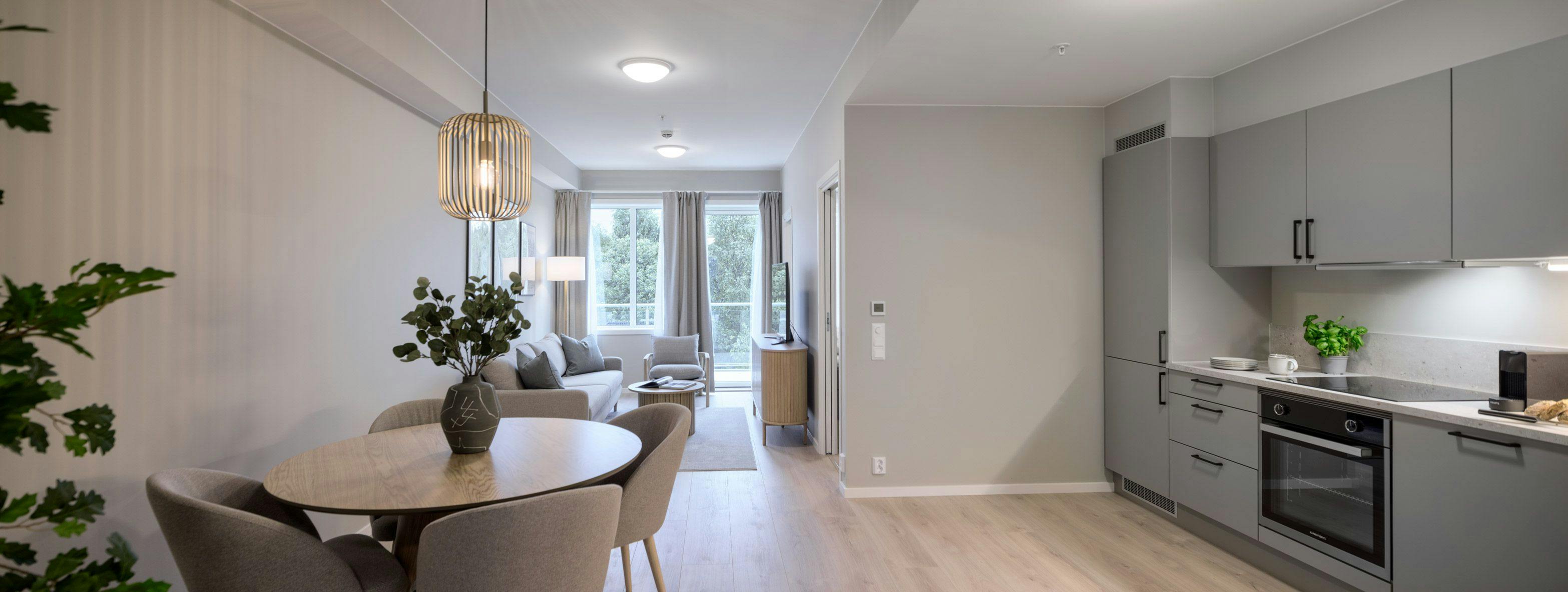 Photo: Kitchen and living room of standard two-bedroom apartment at Hinna location.