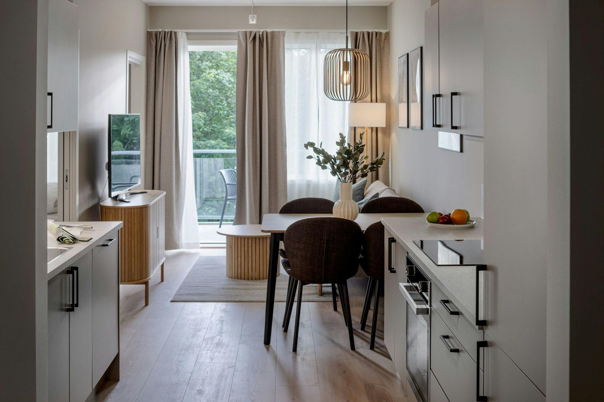 Photo: Kitchen and living room of standard one-bedroom apartment at Hinna location.