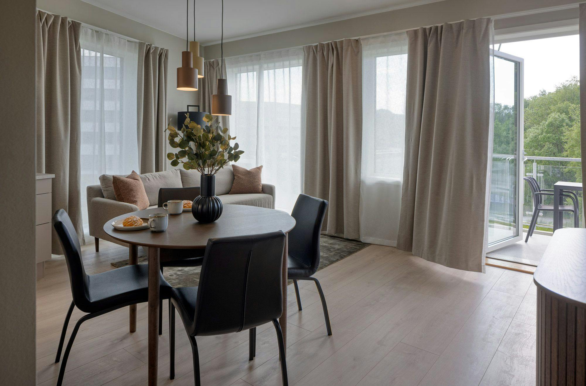 Photo: Living room of premium one-bedroom apartment at Hinna location.